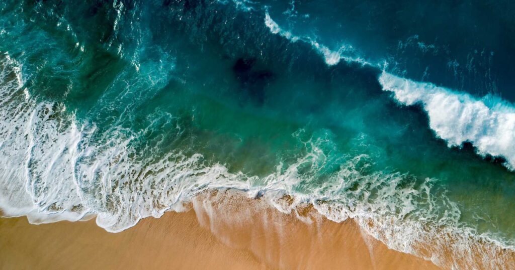 Ocean waves breaking on a sandy beach