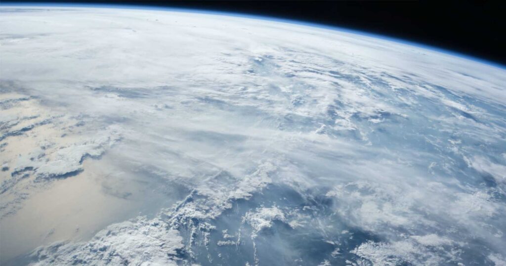 Atmosphere of Earth with clouds and ocean viewed from space